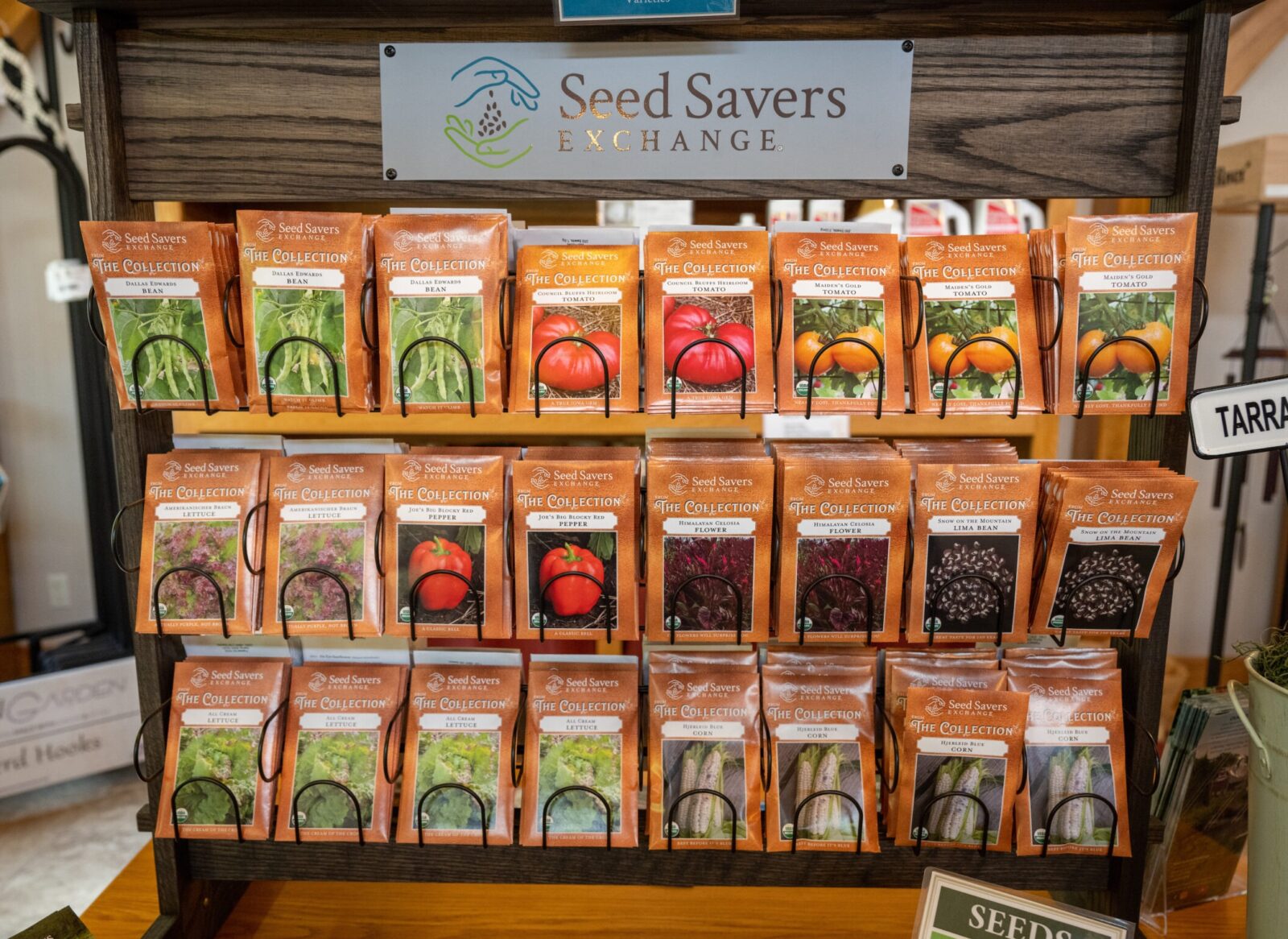 A rack of seed packets with the Seed Savers Exchange logo on top.