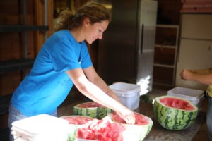 A woman processing watermelon seeds with her hands