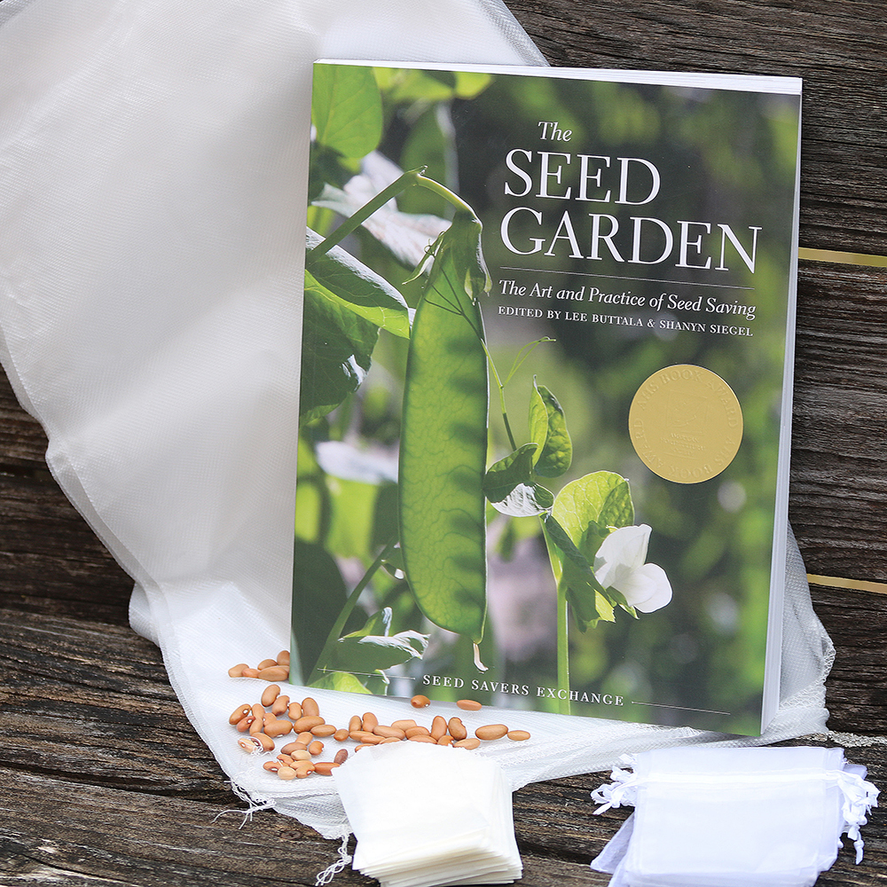 Large white mesh bags, a book, small envelopes, and small blossom bags arranged on a bench