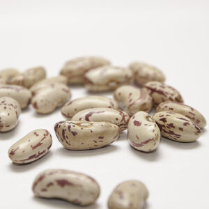 A cluster of peach-colored beans with red speckles