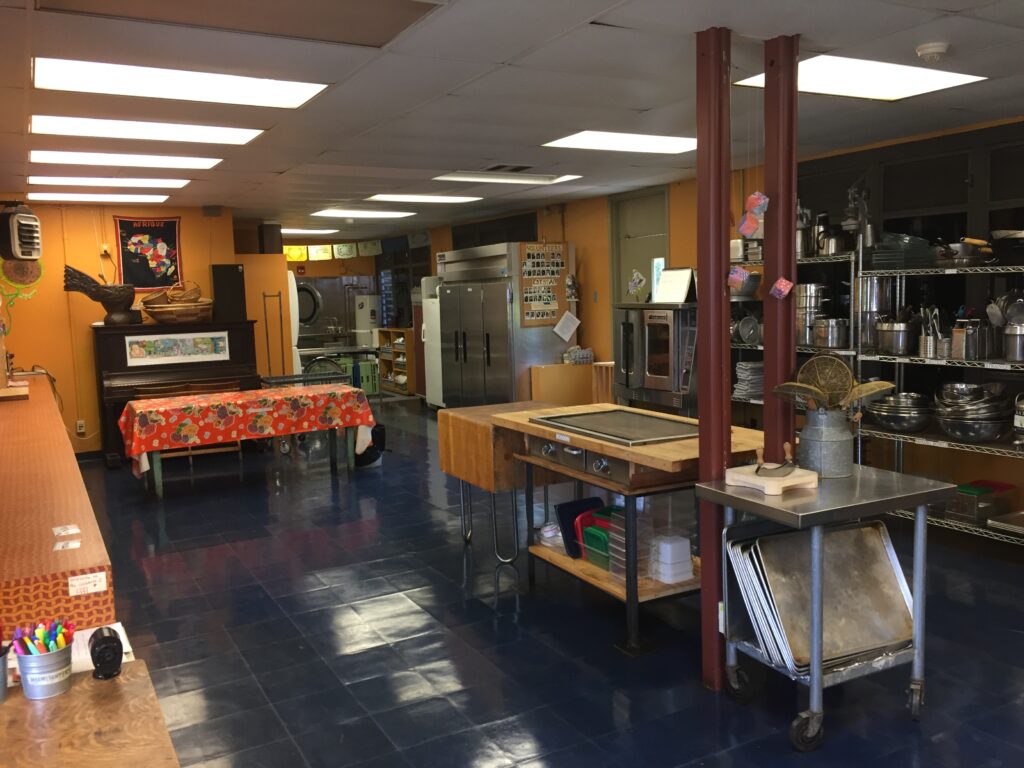 A large commercial-style kitchen classroom for food-related curriculum.