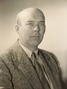 A sepia portrait of John Withee in a suit