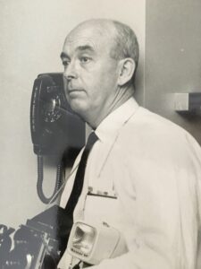 An old black and white photograph of John Withee with a camera.