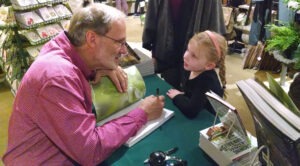 Craig LeHoullier meets a young fan at a book-signing event in 2015.