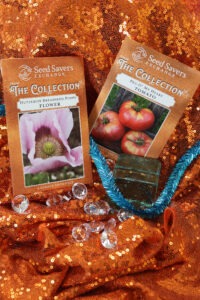 Several seed packets, gems, ribbon, and ornaments on glittery orange fabric
