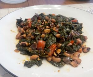 A plate with black-eyed peas and collard greens