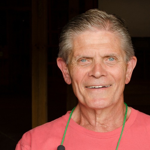 A smiling man in a red shirt