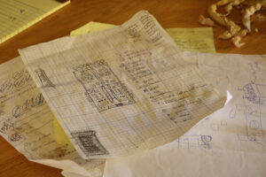 papers with sketches on a wooden table