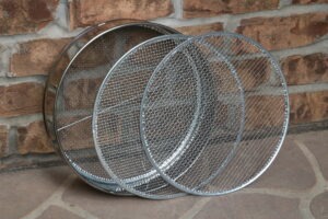 A soil sieve kit comprising of three metal screens and a round frame