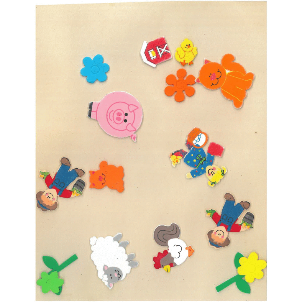 A tan scrapbook page covered in stickers of farmers, animals, and flowers